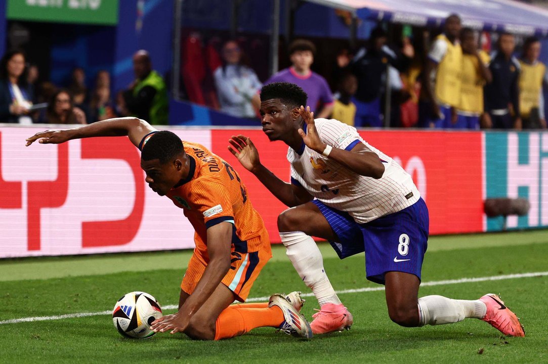 El neerlandés Denzel Dumfries (I) y el francés Aurelien Djani Tchouameni durante el partido del grupo D que han jugado Países Bajos y Francia en Leipzig, Alemania. EFE/EPA/ANNA SZILAGYI